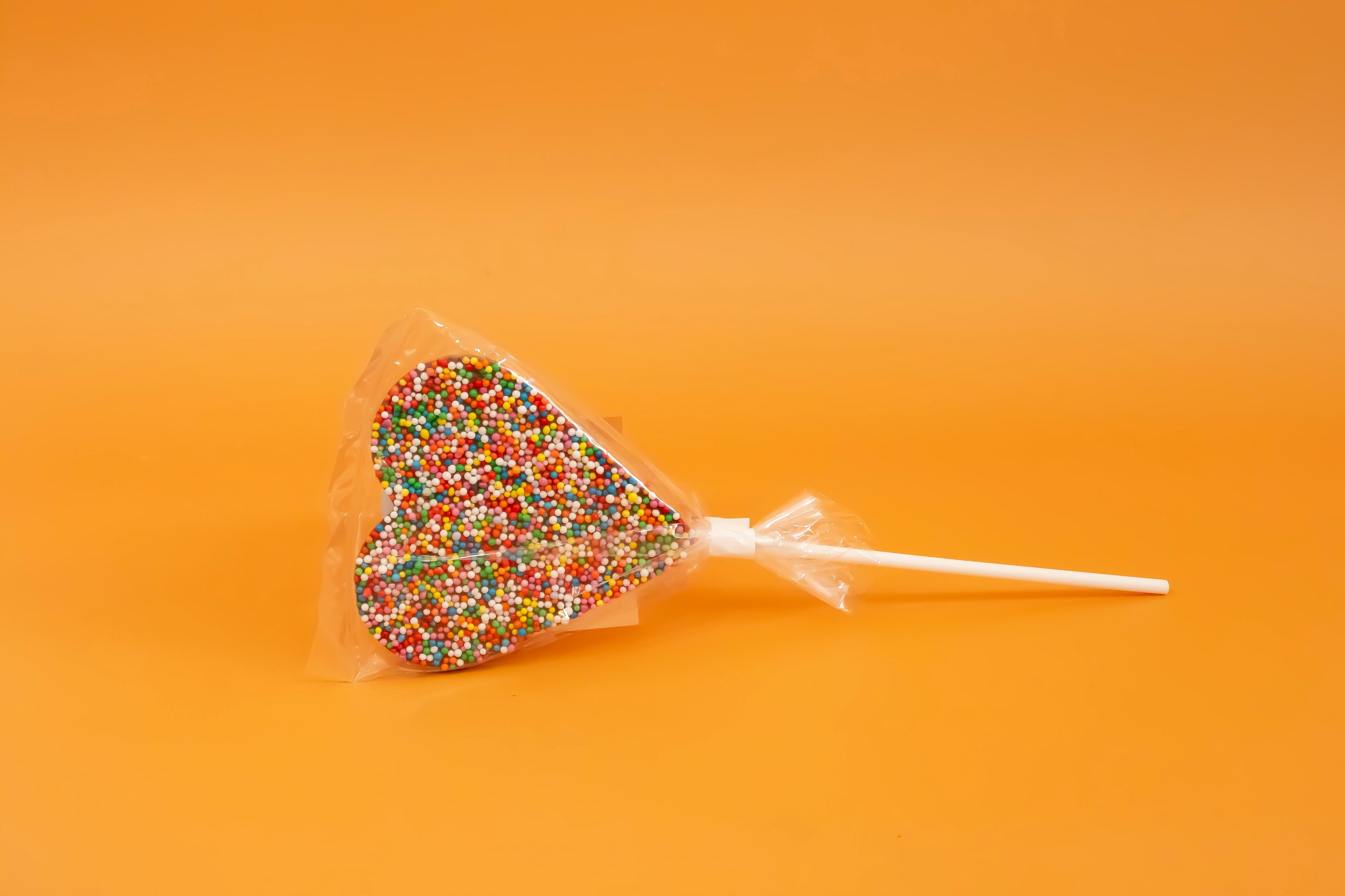 Sprinkles chocolate heard lollypop. 