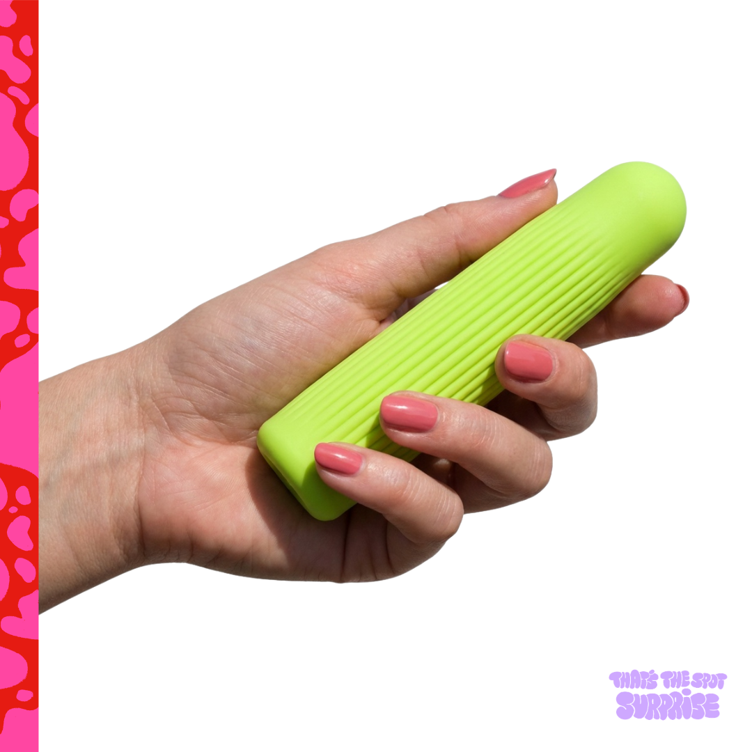 Hand holding a green ribbed mini-bullet style vibrator from That's The Spot Surprise blind box.