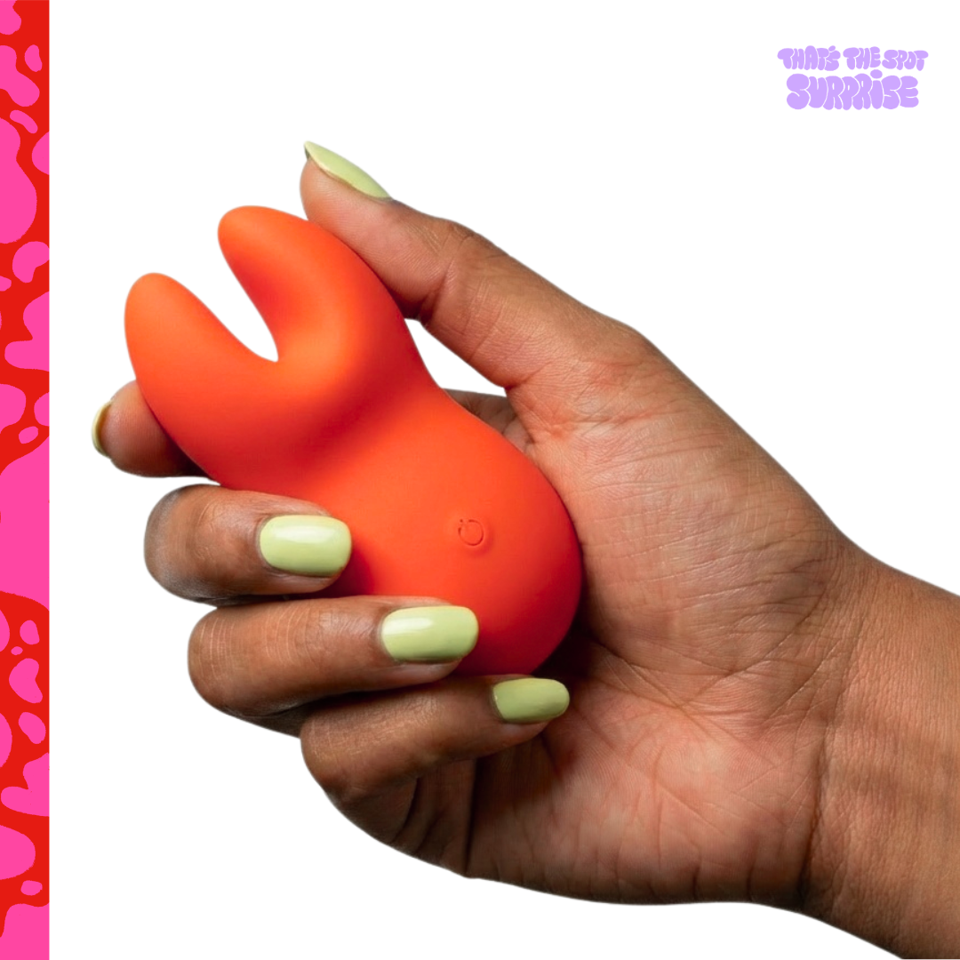Hand holding a red dual-tip silicone vibrator from That's The Spot Surprise blind box.
