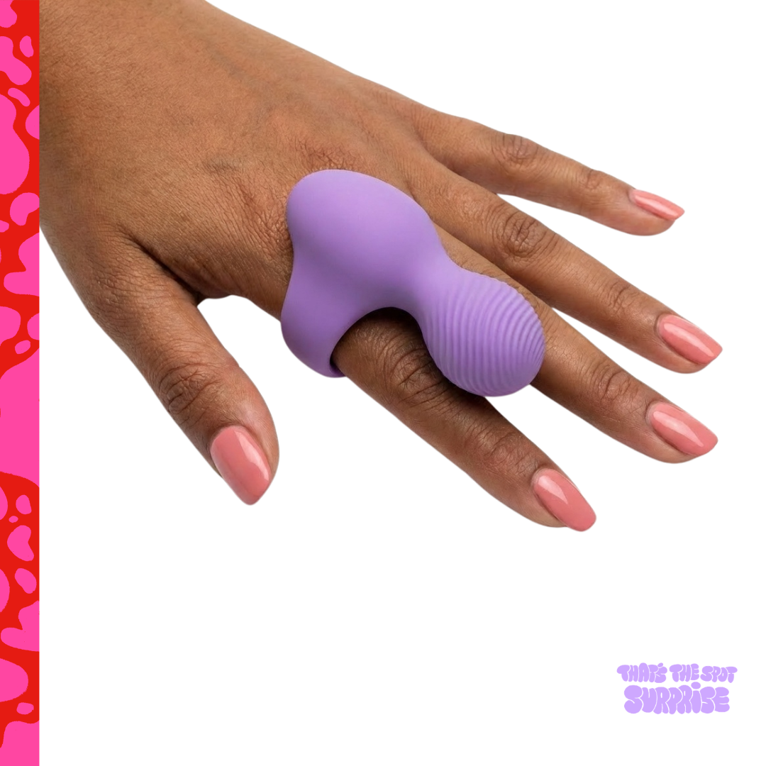 Purple finger ring vibrator being worn on a hand from That's The Spot Surprise blind box.