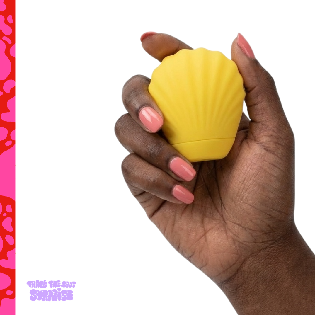 Hand holding a yellow suction vibrator from That's The Spot Surprise blind box.